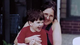 A video still of Immunize.org founder Deborah L. Wexler, MD, with a young boy, speaking about post-polio syndrome.